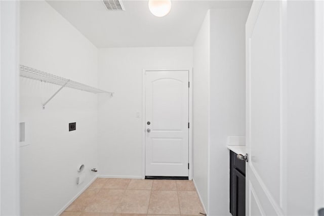 laundry area featuring light tile patterned flooring, laundry area, visible vents, baseboards, and electric dryer hookup