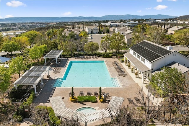 community pool with a mountain view and a community hot tub