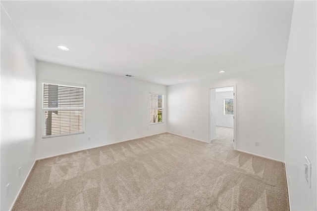 empty room with light carpet, baseboards, visible vents, and recessed lighting