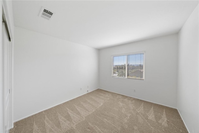 carpeted spare room with visible vents