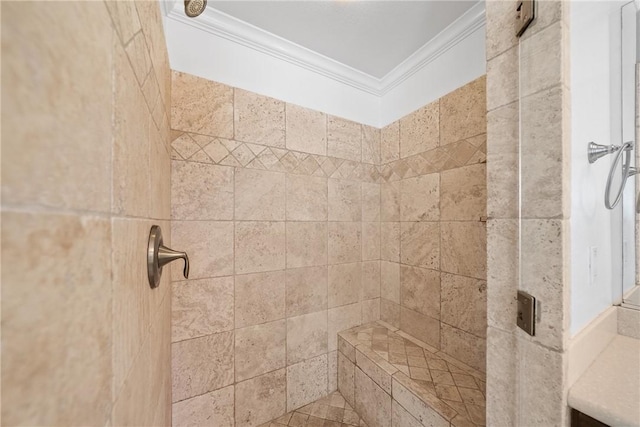 details featuring a tile shower and crown molding