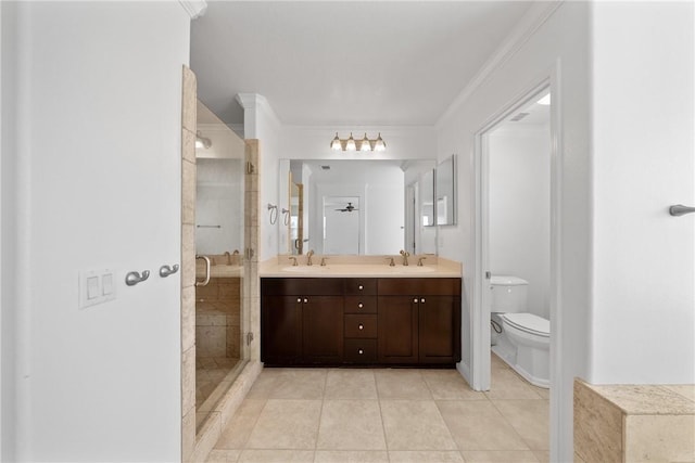 bathroom featuring a stall shower, tile patterned flooring, a sink, and toilet