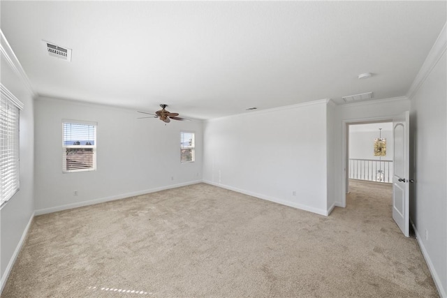 empty room with light carpet, visible vents, and crown molding