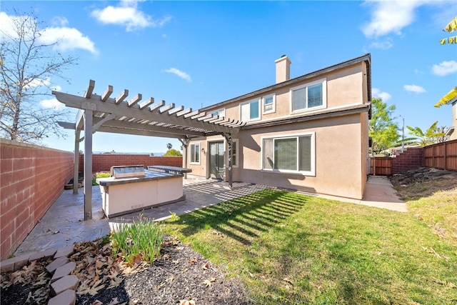 back of house featuring stucco siding, a fenced backyard, a pergola, and a patio