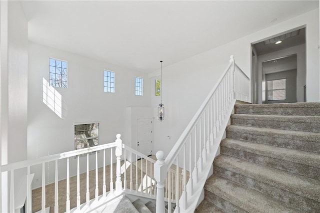 staircase featuring a high ceiling