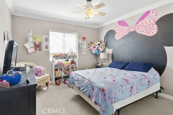 bedroom featuring a ceiling fan, baseboards, ornamental molding, and carpet flooring