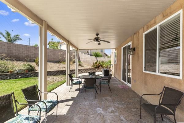 view of patio featuring fence private yard, outdoor dining area, and ceiling fan