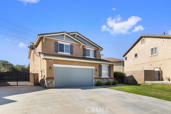 view of front of property with concrete driveway, an attached garage, and stucco siding