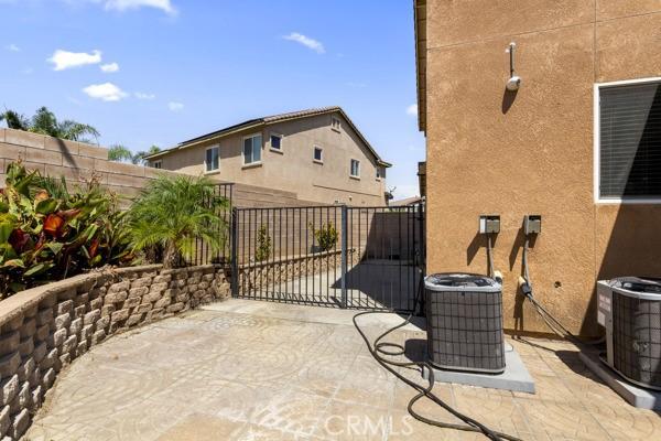 view of patio / terrace featuring a gate, central AC, and fence