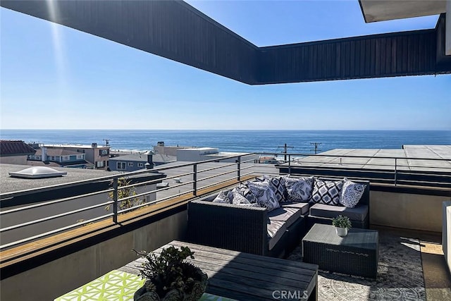 balcony with a water view and an outdoor living space