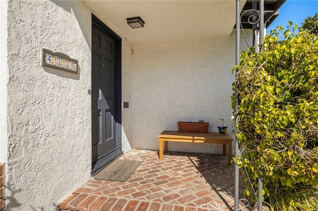 doorway to property with stucco siding