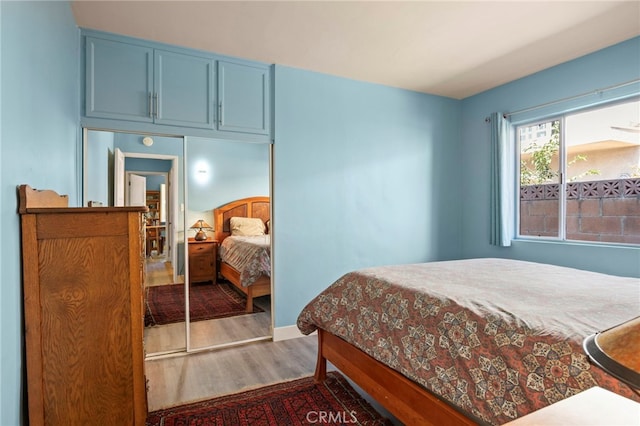 bedroom with wood finished floors and baseboards