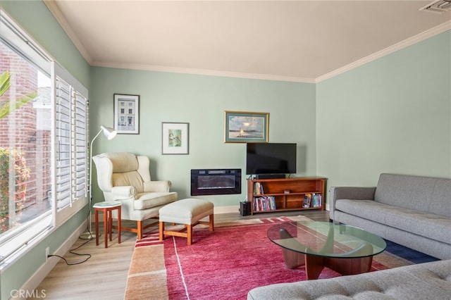 living area featuring ornamental molding, visible vents, wood finished floors, and baseboards