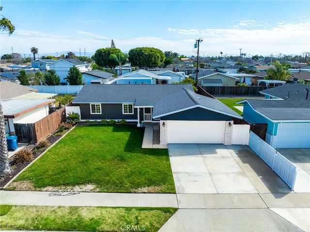 view of front facade featuring a front yard, concrete driveway, brick siding, and fence