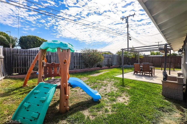 view of playground with a patio area, a lawn, and a fenced backyard