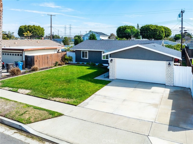 ranch-style house featuring concrete driveway, a front yard, fence, and stucco siding