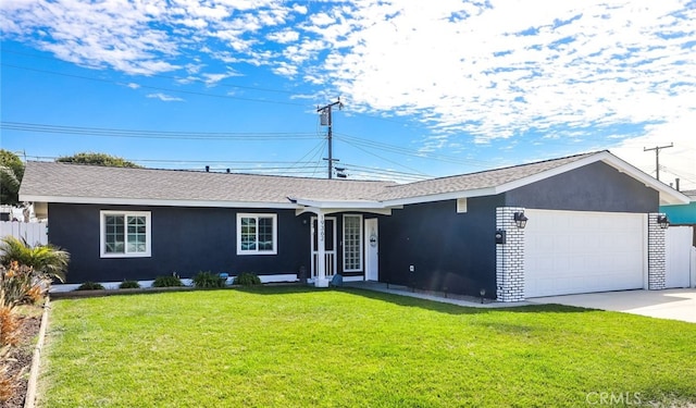 ranch-style house featuring a garage, brick siding, driveway, stucco siding, and a front lawn