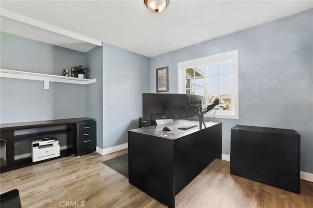 office with light wood-type flooring and baseboards