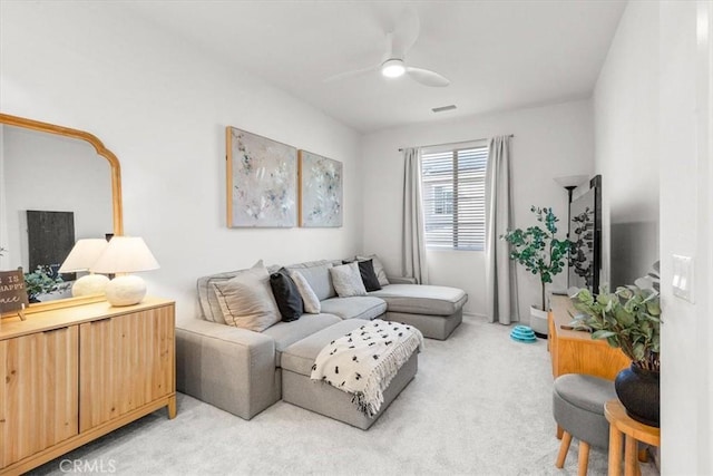 living area with light carpet, ceiling fan, and visible vents