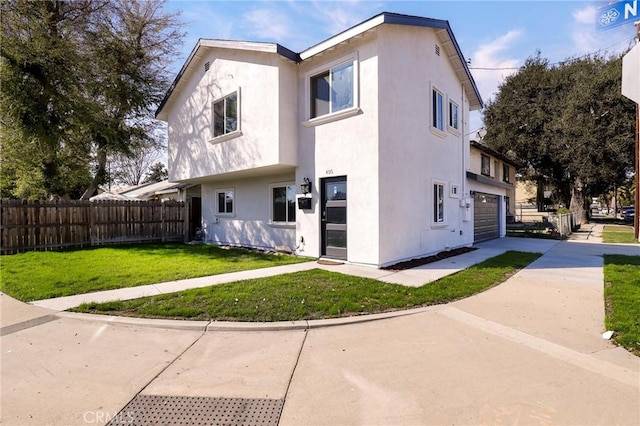 view of front of house with a front yard, concrete driveway, fence, and stucco siding