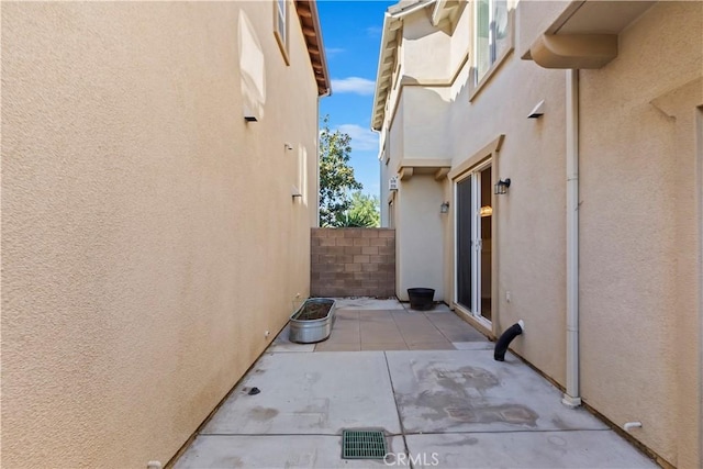 view of patio with fence and visible vents