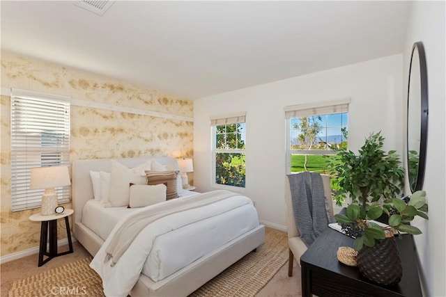 bedroom featuring wallpapered walls, visible vents, baseboards, and light colored carpet