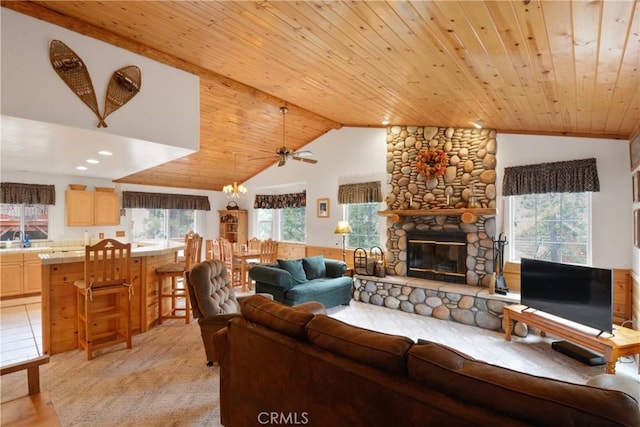 living area with vaulted ceiling, wooden ceiling, light colored carpet, and a fireplace