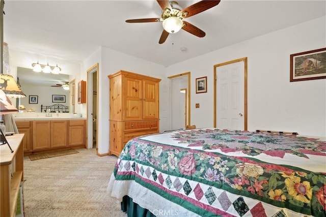 bedroom with light carpet, ceiling fan, and ensuite bathroom