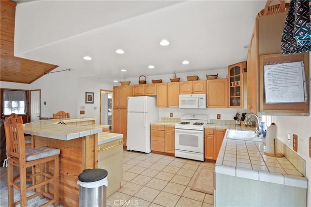 kitchen featuring glass insert cabinets, white appliances, a sink, and tile countertops