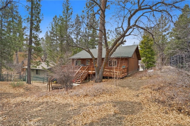 view of front facade featuring fence and a wooden deck