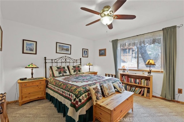 carpeted bedroom featuring a ceiling fan and baseboards