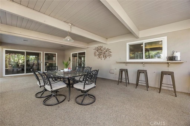 dining area featuring wood ceiling and beam ceiling