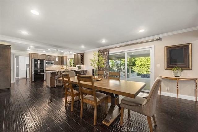 dining room with baseboards, ornamental molding, dark wood-style flooring, and recessed lighting