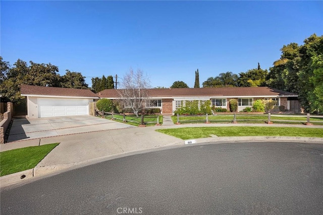 single story home with a garage and a front yard