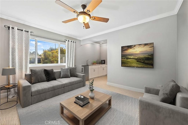 living area featuring crown molding, light carpet, a ceiling fan, and baseboards