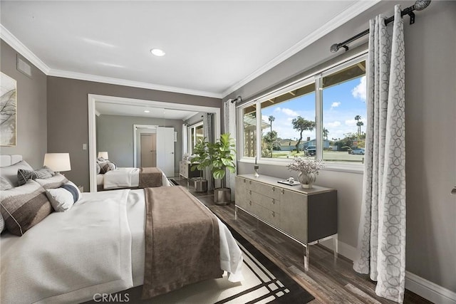 bedroom featuring baseboards, visible vents, ornamental molding, and dark wood-type flooring