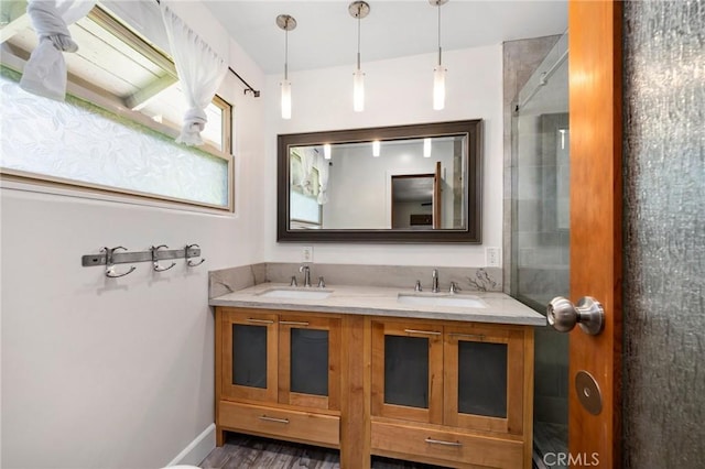 bathroom featuring a sink, baseboards, and double vanity