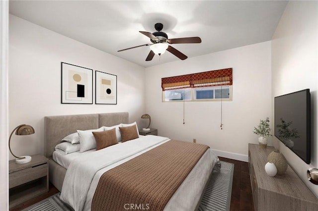 bedroom featuring dark wood-style floors, ceiling fan, baseboards, and a baseboard heating unit