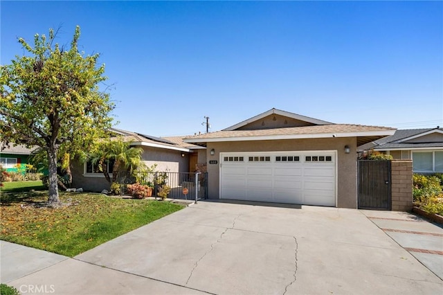 ranch-style house featuring a garage, solar panels, driveway, a gate, and stucco siding