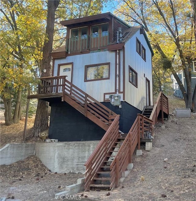 rustic home with stairway and a balcony