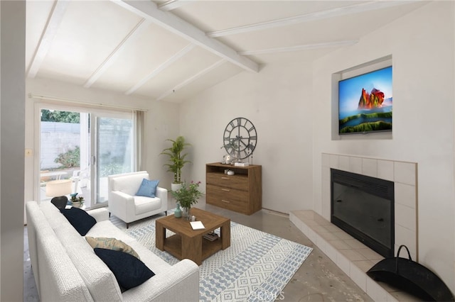 living room featuring vaulted ceiling with beams, concrete flooring, and a tiled fireplace