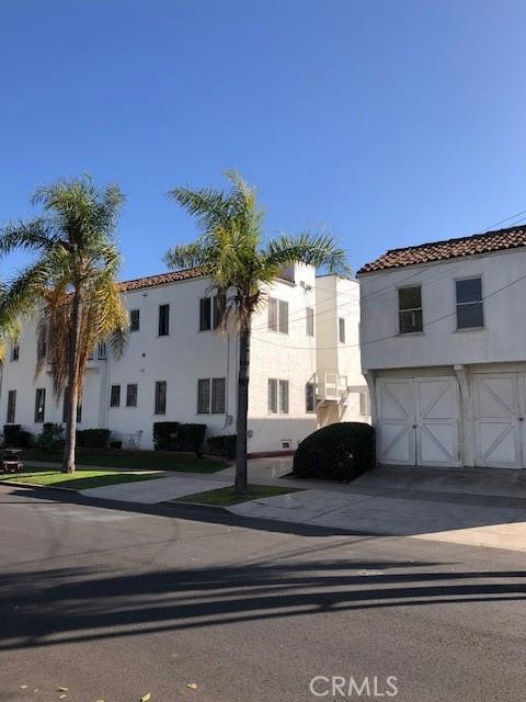 view of front of home with a garage, concrete driveway, and stucco siding