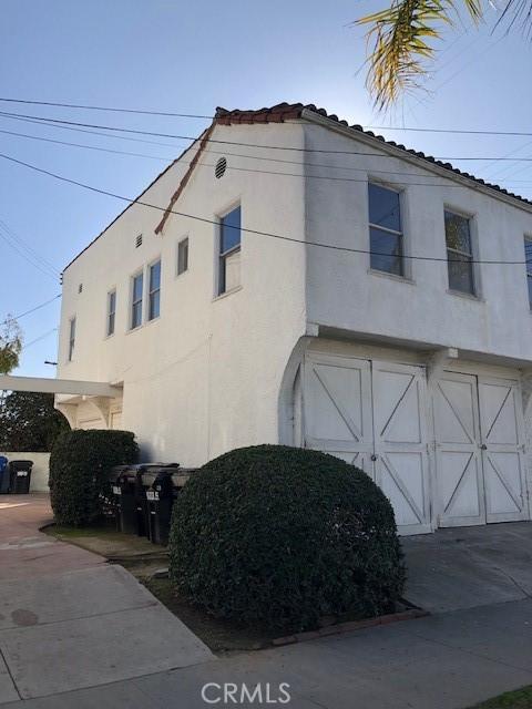 view of property exterior featuring an attached garage and stucco siding