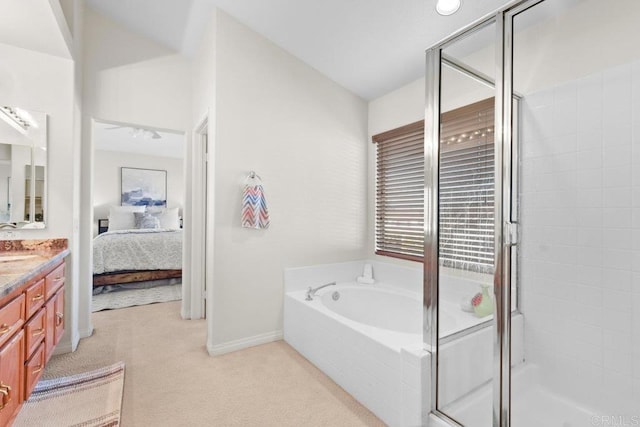 full bathroom with a garden tub, a stall shower, vanity, ensuite bath, and baseboards