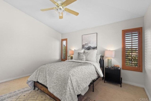 bedroom with carpet flooring, multiple windows, vaulted ceiling, and baseboards