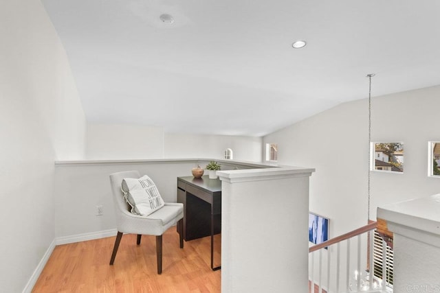 interior space featuring vaulted ceiling, recessed lighting, wood finished floors, and baseboards