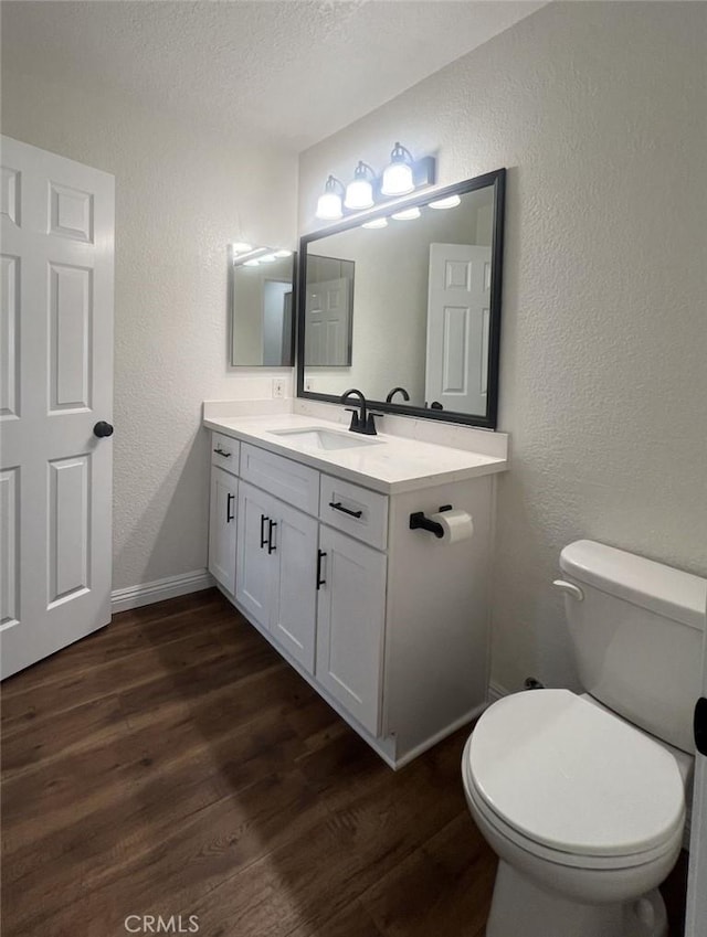 25614 Mont Pointe Unit 3D, Lake Forest, CA 92630 - half bathroom with a textured wall, wood finished floors, vanity, and a textured ceiling