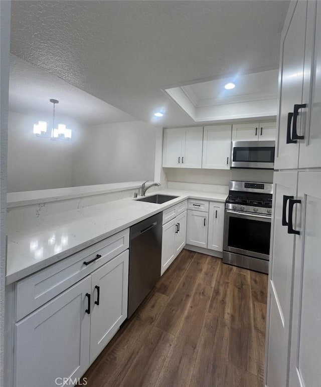 25614 Mont Pointe Unit 3D, Lake Forest, CA 92630 - kitchen featuring appliances with stainless steel finishes, a tray ceiling, white cabinetry, recessed lighting, and dark wood-style floors