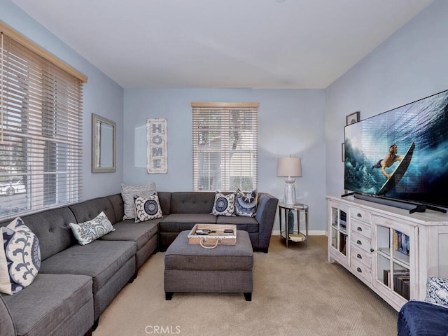 living room featuring light carpet and baseboards