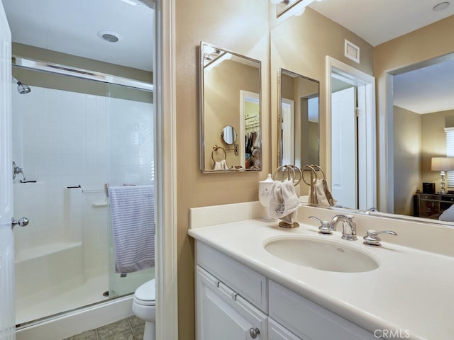 bathroom featuring visible vents, toilet, tile patterned flooring, vanity, and a shower stall